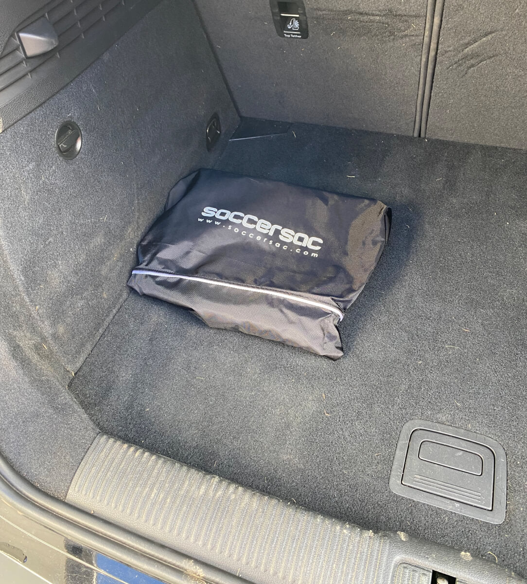 Soccersac rolled up and stored in a boot